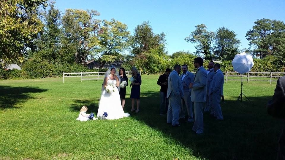 Olivia and Marcus’s wedding, photo 3 — bride and wedding party on the lawn