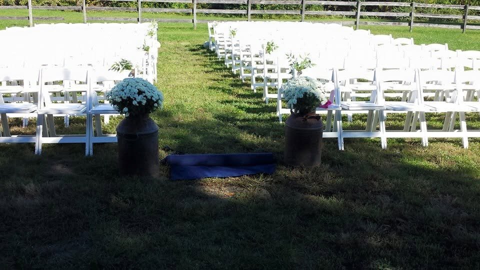 Jenna and Cole’s wedding, photo 2 — ceremony aisle lined with vintage milk cans